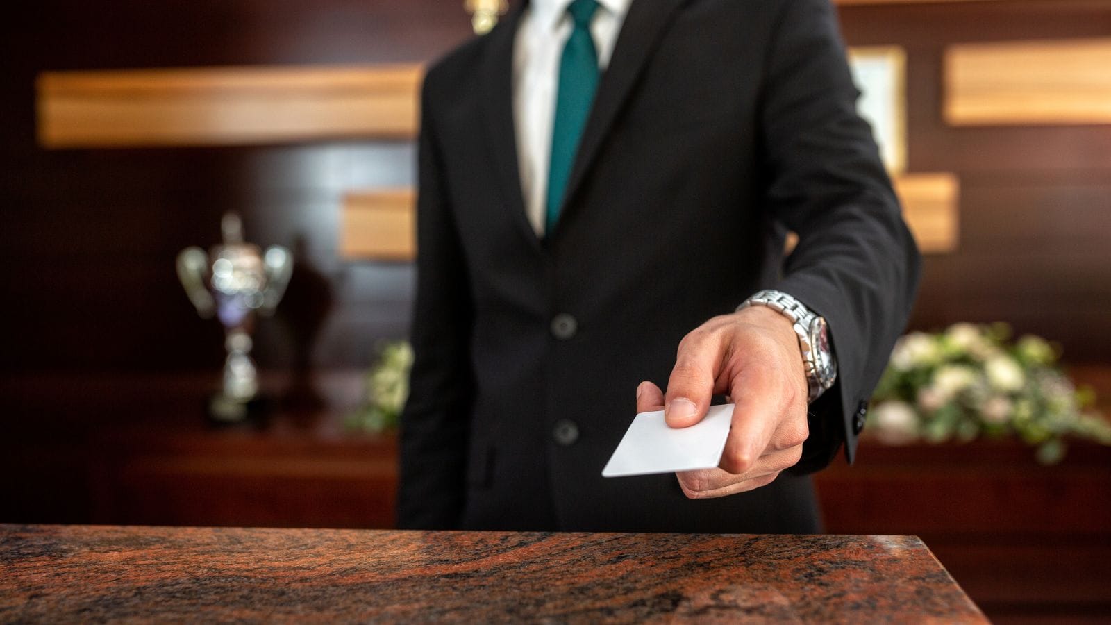 Close-up of a hand receiving a hotel key card, relevant to Hotel Injury and Negligence legal services offered by Kevin R. Hansen in Las Vegas