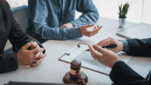 Group of individuals in a conference, accompanied by an attorney diligently taking notes, exemplifying the comprehensive legal counsel provided by Kevin R. Hansen, Personal Injury Lawyer in Las Vegas
