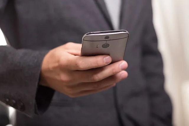 Man in suit dialing a cell phone, symbolizing the immediate legal assistance available at Kevin R. Hansen's Las Vegas personal injury law firm