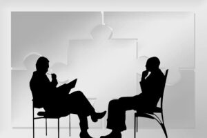 Silhouetted figures of an attorney and client discussing a personal injury case, symbolic of the client-focused approach at Kevin R. Hansen's Las Vegas law firm