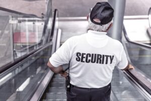 Security guard descending an escalator, illustrating the scrutiny required in cases of potential security negligence handled by Kevin R. Hansen, Las Vegas Hotel Injury Lawyer