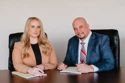 Kevin R. Hansen and Associate Attorney Amanda A. Harmon seated at a conference table, showcasing the dynamic legal team at the Law Office of Kevin R. Hansen, dedicated Personal Injury Lawyers in Las Vegas