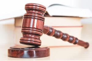 Close-up of judge's gavel with legal books in the background, symbolizing the pursuit of justice in personal injury cases by Kevin R. Hansen, Las Vegas Lawyer