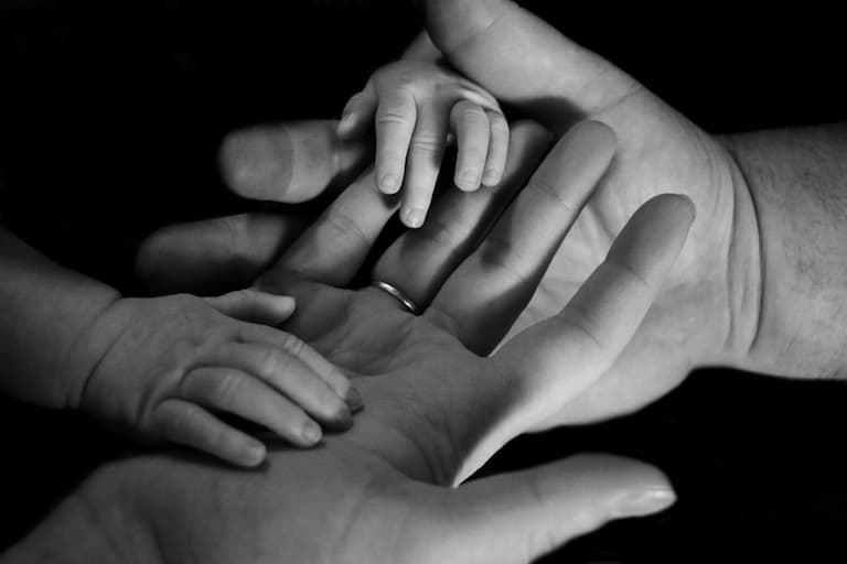 parent and child intertwining hands